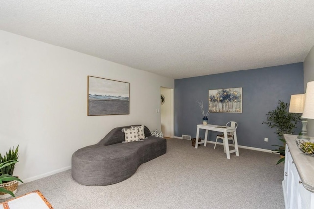 2135 1st Ave SE Unit 125, Cedar Rapids, IA 52402 - living room featuring a textured ceiling and carpet
