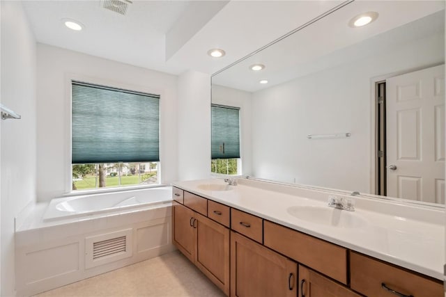 4309 Woodsonia Ct NW, Cedar Rapids, IA 52405 - bathroom with a bath, double vanity, and recessed lighting