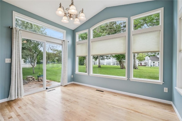 4309 Woodsonia Ct NW, Cedar Rapids, IA 52405 - unfurnished dining area featuring lofted ceiling, a chandelier, and wood finished floors