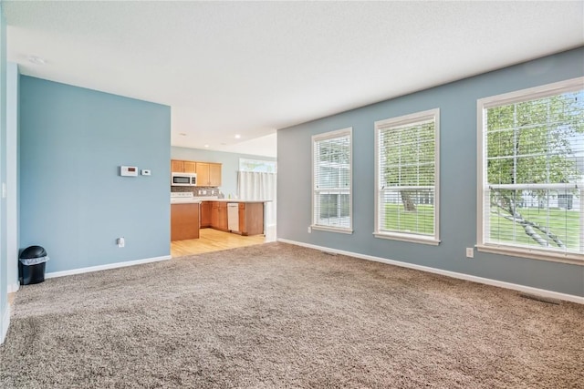 4309 Woodsonia Ct NW, Cedar Rapids, IA 52405 - unfurnished living room featuring light carpet and recessed lighting