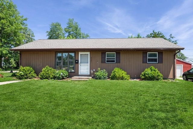 4524 Benton St, Cedar Rapids, IA 52402 - ranch-style house with a front yard, roof with shingles, and a detached garage