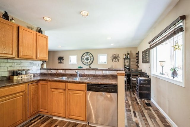 4524 Benton St, Cedar Rapids, IA 52402 - kitchen featuring dishwasher, dark wood-style flooring, dark countertops, a peninsula, and backsplash