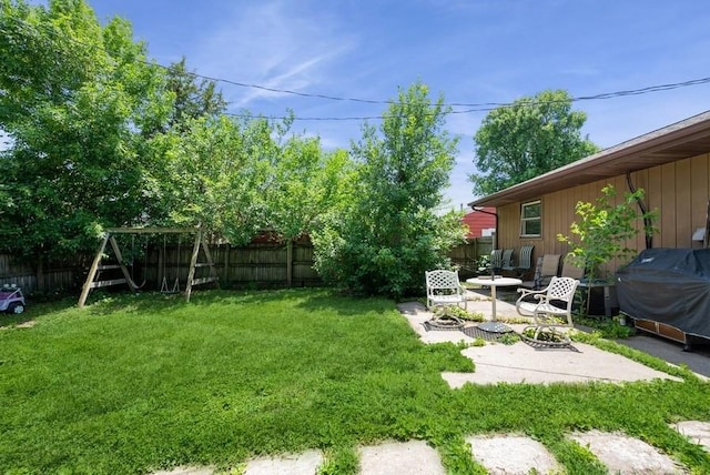 4524 Benton St, Cedar Rapids, IA 52402 - fenced backyard with a fire pit, a patio, and a playground