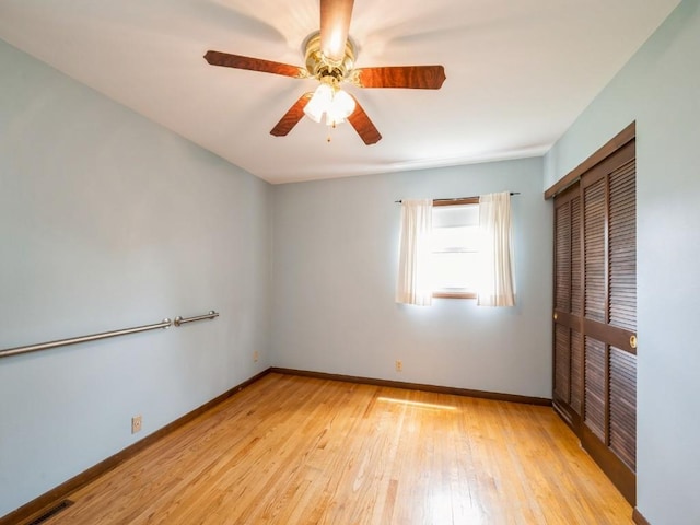 4634 Twin Pine Dr NE, Cedar Rapids, IA 52402 - unfurnished bedroom with a closet, light wood-style flooring, and ceiling fan