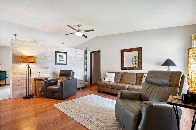 4633 White Pine Dr NE, Cedar Rapids, IA 52402 - living area featuring a ceiling fan, vaulted ceiling, wood finished floors, and wooden walls