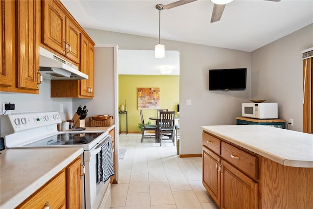4633 White Pine Dr NE, Cedar Rapids, IA 52402 - kitchen featuring white appliances, under cabinet range hood, vaulted ceiling, brown cabinetry, and light countertops