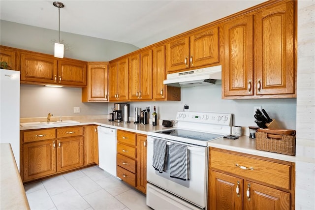 4633 White Pine Dr NE, Cedar Rapids, IA 52402 - kitchen with white appliances, under cabinet range hood, vaulted ceiling, brown cabinets, and light countertops