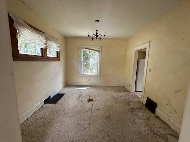 618 18th St SE, Cedar Rapids, IA 52403 - unfurnished dining area with a chandelier and carpet floors