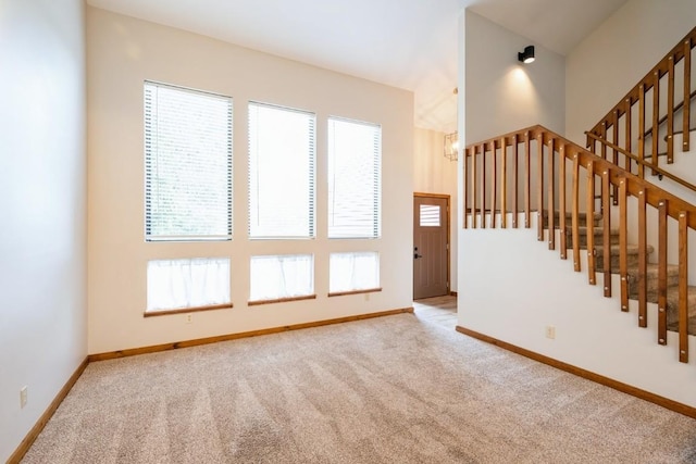 3524 Swallow Ct NE, Cedar Rapids, IA 52402 - unfurnished living room with carpet, healthy amount of natural light, and stairway