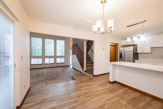 3524 Swallow Ct NE, Cedar Rapids, IA 52402 - kitchen featuring stainless steel fridge with ice dispenser, light countertops, plenty of natural light, and white cabinets