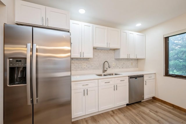 3524 Swallow Ct NE, Cedar Rapids, IA 52402 - kitchen featuring stainless steel appliances, light wood-type flooring, light countertops, white cabinetry, and decorative backsplash