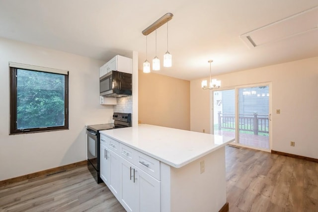 3524 Swallow Ct NE, Cedar Rapids, IA 52402 - kitchen with electric range, stainless steel microwave, a peninsula, and plenty of natural light