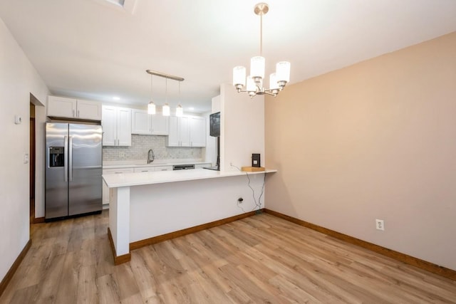 3524 Swallow Ct NE, Cedar Rapids, IA 52402 - kitchen with stainless steel appliances, backsplash, light wood-style floors, light countertops, and a peninsula
