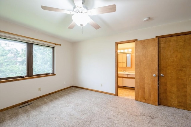 3524 Swallow Ct NE, Cedar Rapids, IA 52402 - unfurnished bedroom with light colored carpet, connected bathroom, and ceiling fan