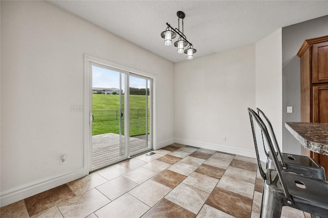 881 Shade Tree Ct, Lisbon, IA 52253 - unfurnished dining area featuring baseboards