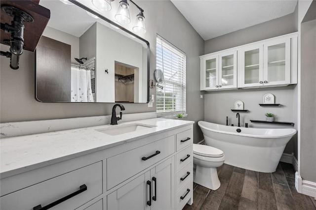 881 Shade Tree Ct, Lisbon, IA 52253 - full bathroom with vanity, wood finished floors, a freestanding tub, and a shower with curtain