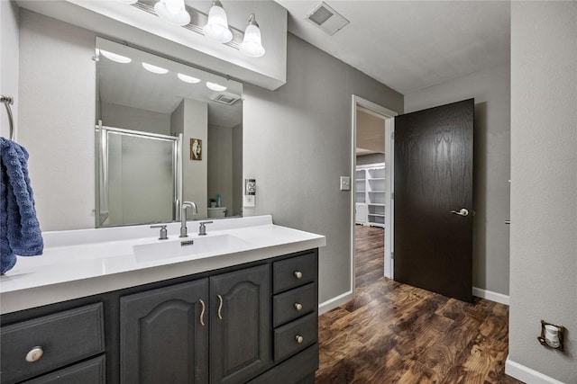 881 Shade Tree Ct, Lisbon, IA 52253 - bathroom with wood finished floors, a shower stall, and vanity
