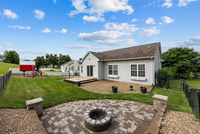 881 Shade Tree Ct, Lisbon, IA 52253 - rear view of house with a patio area, a playground, a fenced backyard, and a fire pit