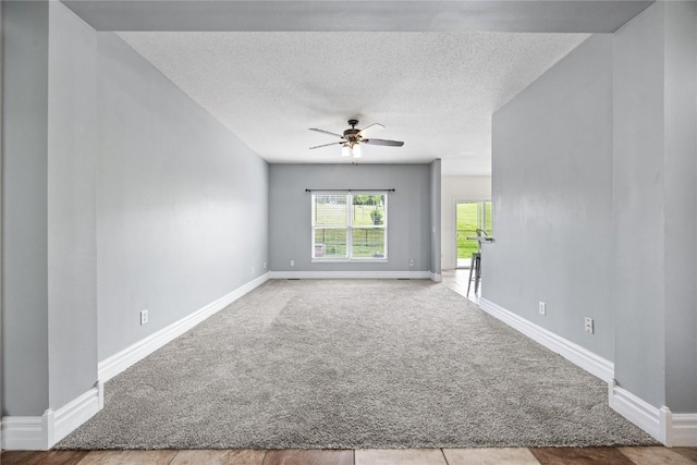 881 Shade Tree Ct, Lisbon, IA 52253 - spare room with carpet flooring, ceiling fan, and a textured ceiling