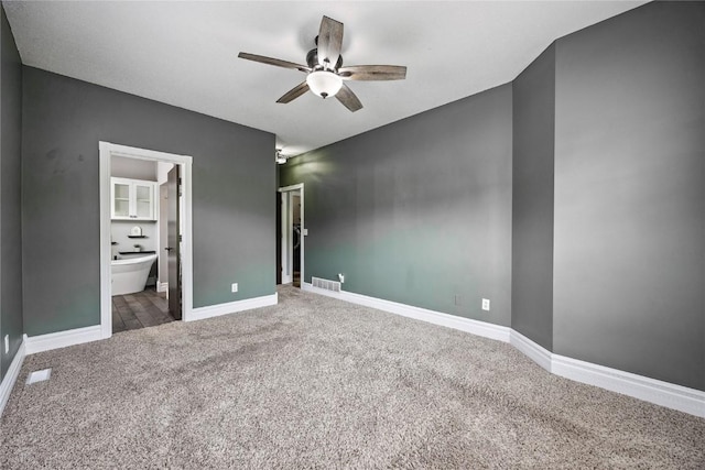 881 Shade Tree Ct, Lisbon, IA 52253 - unfurnished bedroom with carpet floors, ensuite bathroom, and ceiling fan