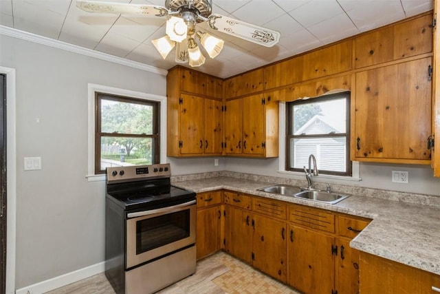 1158 Brown Ave NE, Cedar Rapids, IA 52402 - kitchen with stainless steel electric range, crown molding, a ceiling fan, brown cabinetry, and light countertops