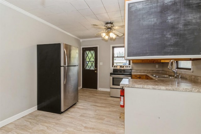 1158 Brown Ave NE, Cedar Rapids, IA 52402 - kitchen featuring appliances with stainless steel finishes, crown molding, ceiling fan, and light countertops