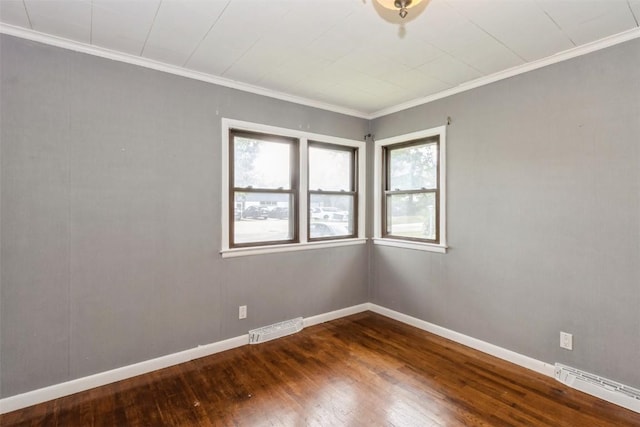 1158 Brown Ave NE, Cedar Rapids, IA 52402 - unfurnished room with a baseboard radiator, dark wood-type flooring, and crown molding