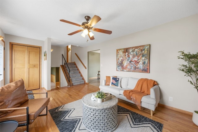 52 Thompson Dr, Palo, IA 52324 - living area with light wood-style flooring, stairs, and a ceiling fan