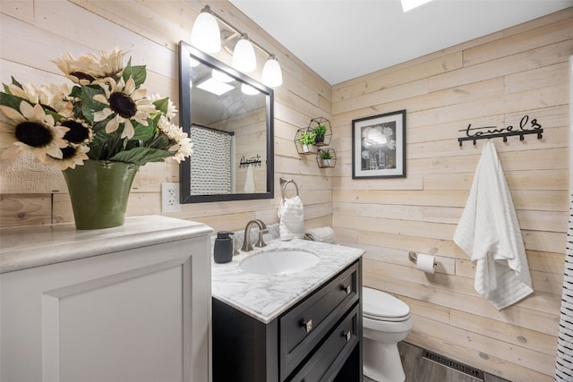 52 Thompson Dr, Palo, IA 52324 - bathroom featuring vanity, wood walls, curtained shower, and wood finished floors