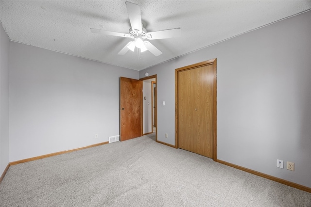 52 Thompson Dr, Palo, IA 52324 - unfurnished bedroom featuring carpet, a closet, ceiling fan, and a textured ceiling