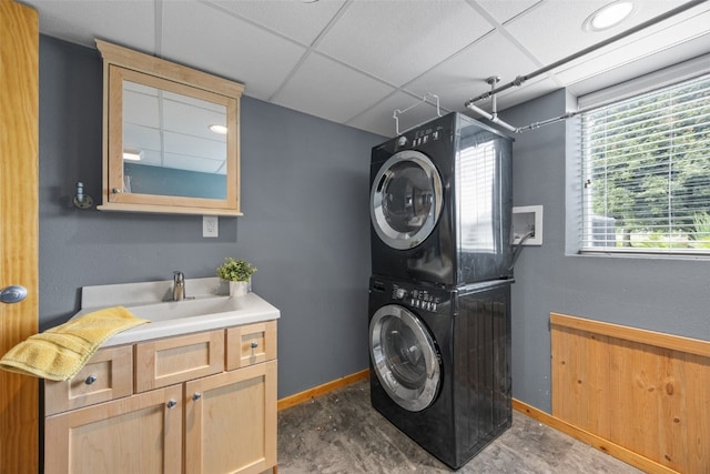 52 Thompson Dr, Palo, IA 52324 - laundry room featuring stacked washer and clothes dryer and cabinet space