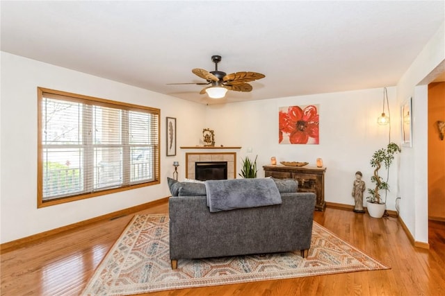 1017 Langenberg Ave, Iowa City, IA 52240 - living room with a fireplace, wood finished floors, and a ceiling fan
