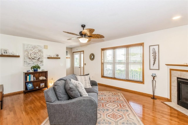 1017 Langenberg Ave, Iowa City, IA 52240 - living room with wood finished floors, ceiling fan, and a fireplace