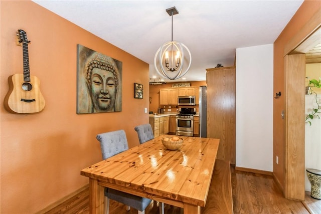 1017 Langenberg Ave, Iowa City, IA 52240 - dining space featuring a chandelier and light wood-style floors