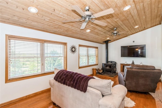 1017 Langenberg Ave, Iowa City, IA 52240 - living room featuring a wood stove, wood ceiling, wood finished floors, ceiling fan, and lofted ceiling