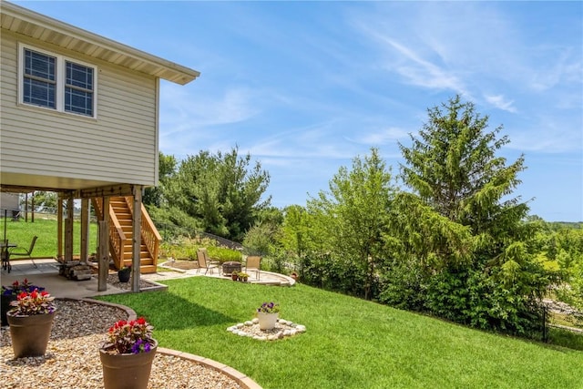1017 Langenberg Ave, Iowa City, IA 52240 - view of green lawn featuring stairway, a patio, and a fire pit
