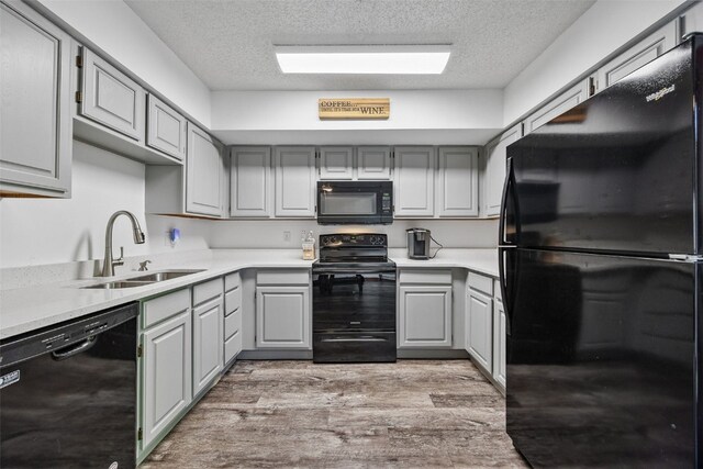 1211 Cambria Ct, Iowa City, IA 52246 - kitchen with black appliances, gray cabinets, a textured ceiling, and light countertops