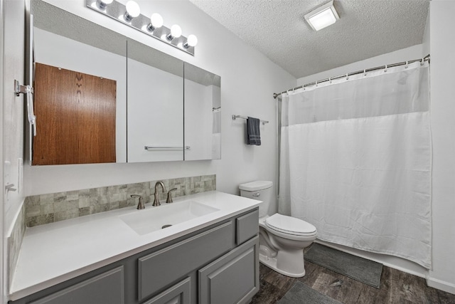 1211 Cambria Ct, Iowa City, IA 52246 - full bathroom with a textured ceiling, vanity, wood finished floors, and a shower with shower curtain