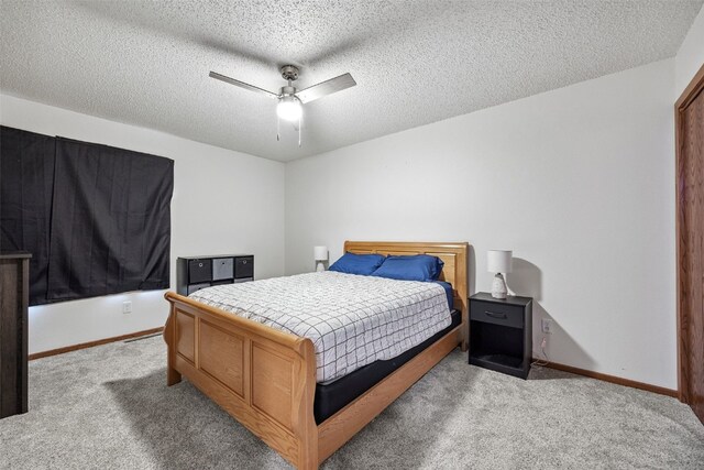 1211 Cambria Ct, Iowa City, IA 52246 - bedroom with light carpet, a textured ceiling, and a ceiling fan