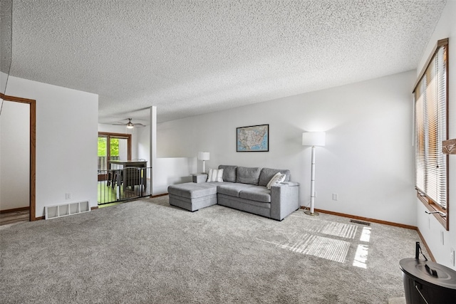 1211 Cambria Ct, Iowa City, IA 52246 - living room featuring carpet flooring, ceiling fan, and a textured ceiling