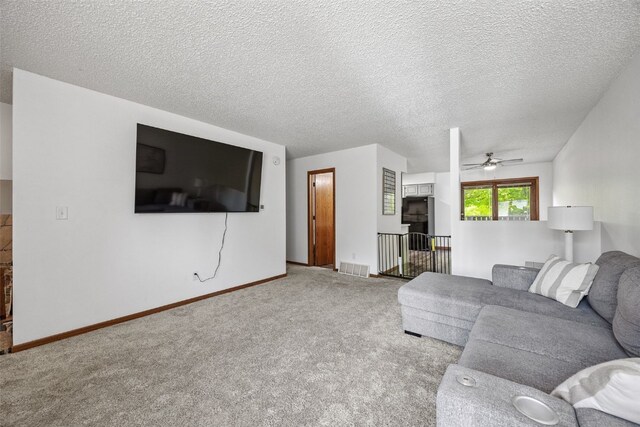 1211 Cambria Ct, Iowa City, IA 52246 - carpeted living area featuring a ceiling fan and a textured ceiling