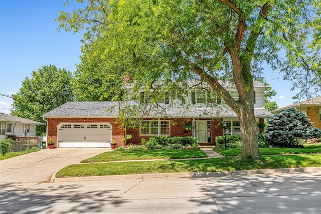 927 Southlawn Dr, Iowa City, IA 52245 - view of front of home featuring an attached garage, brick siding, driveway, and a front yard