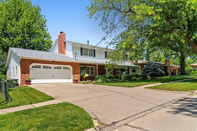 927 Southlawn Dr, Iowa City, IA 52245 - traditional-style home with a chimney, a garage, a front lawn, and brick siding