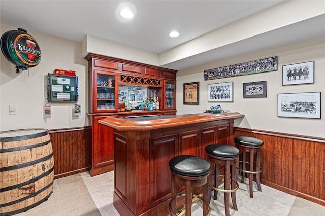 927 Southlawn Dr, Iowa City, IA 52245 - indoor dry bar with wainscoting, light tile patterned floors, wooden walls, and recessed lighting