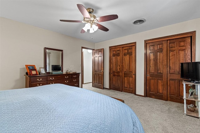 927 Southlawn Dr, Iowa City, IA 52245 - bedroom with carpet, multiple closets, and ceiling fan
