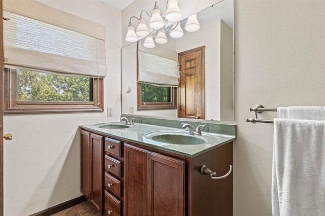 927 Southlawn Dr, Iowa City, IA 52245 - bathroom featuring a chandelier, double vanity, and tile patterned flooring