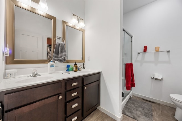 281 Danielle St, Iowa City, IA 52245 - bathroom featuring double vanity, a shower stall, and tile patterned flooring