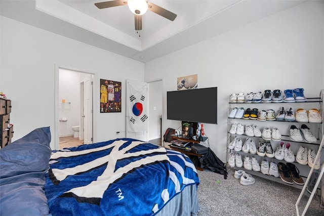 281 Danielle St, Iowa City, IA 52245 - carpeted bedroom with ensuite bath, a ceiling fan, and a tray ceiling