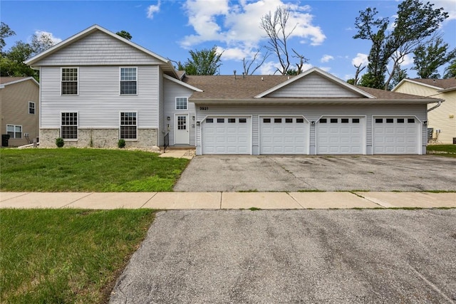 3921 Lexington Dr NE Unit C, Cedar Rapids, IA 52402 - view of front facade with asphalt driveway, a front lawn, and an attached garage