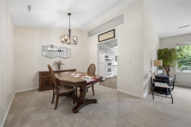 3921 Lexington Dr NE Unit C, Cedar Rapids, IA 52402 - carpeted dining area with a chandelier and baseboards